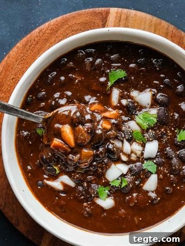 Smoky Black Bean Soup in bowl with spoon inside