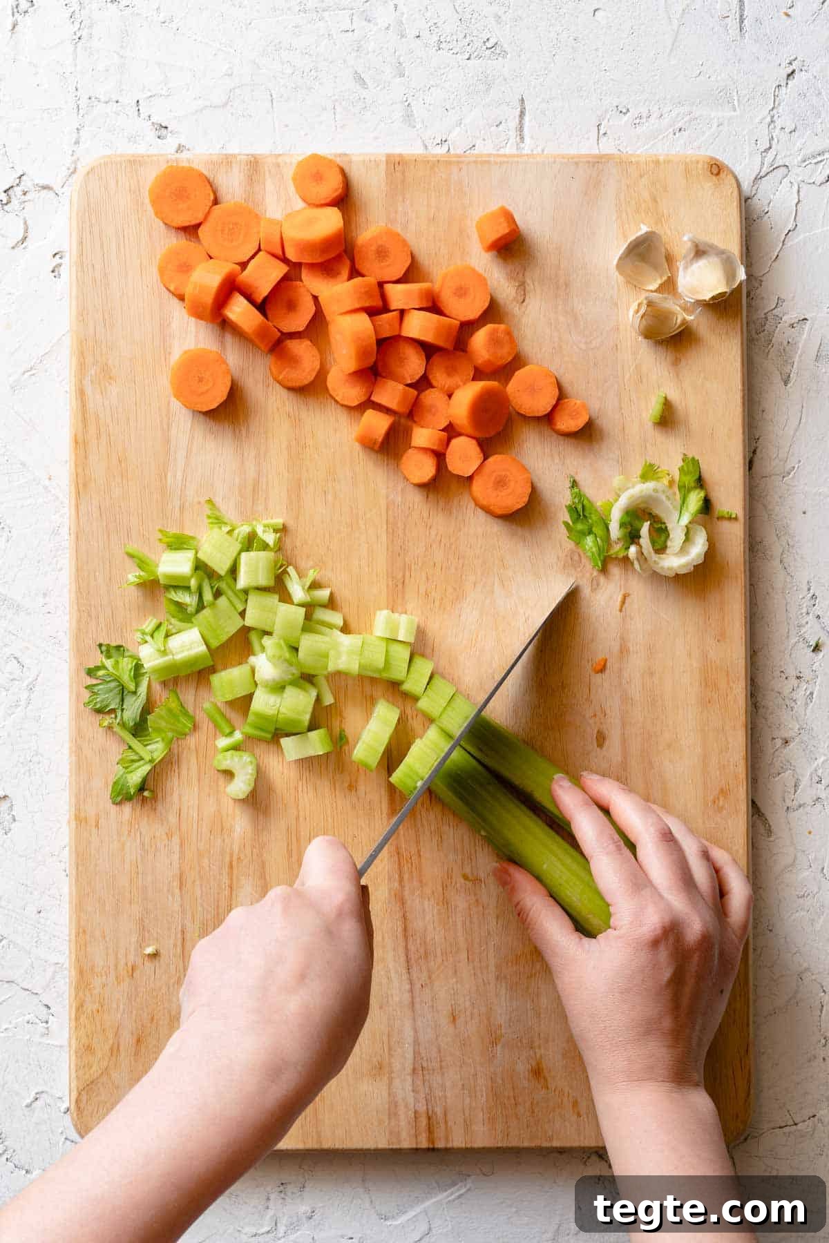 celery being sliced on cutting board