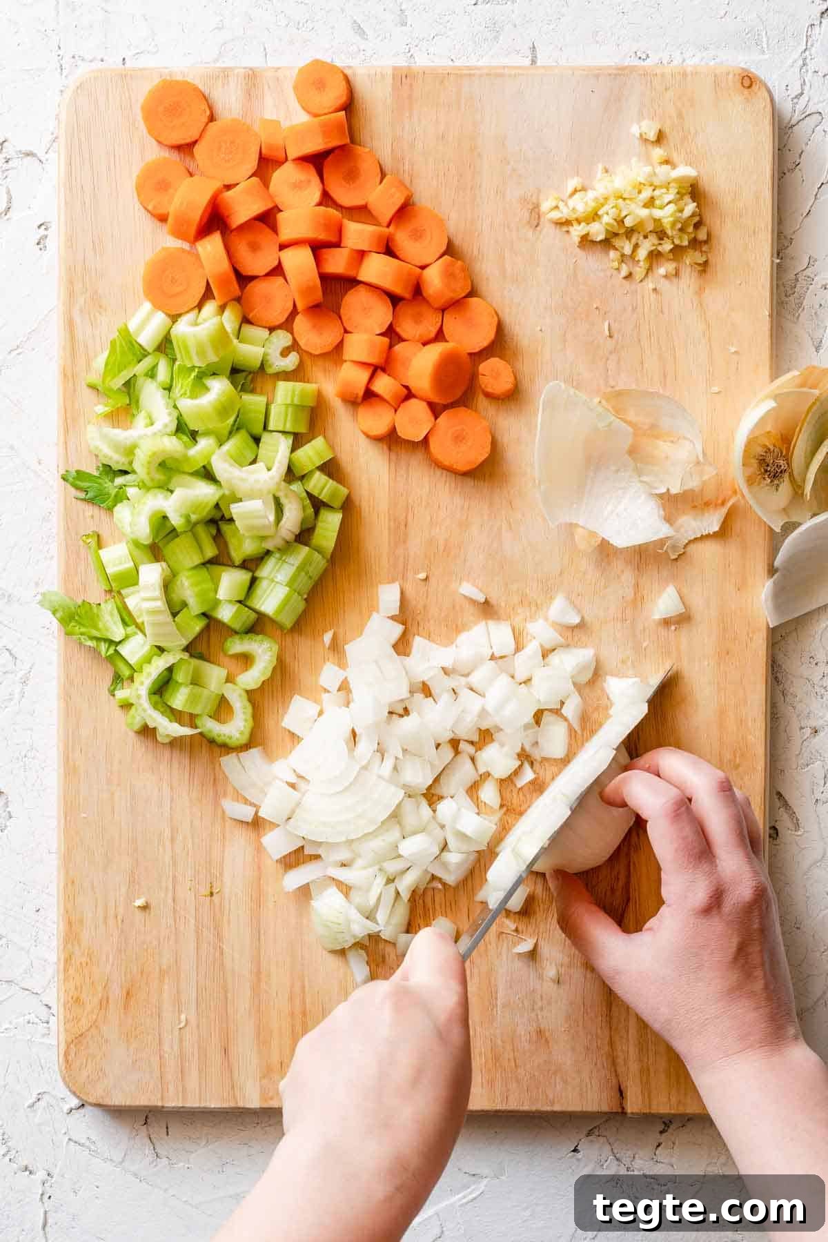 onion being chopped on cutting board