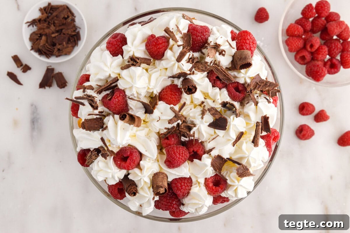 Decadent Raspberry Trifle Recipe with Fresh Cream and Cake 16 raspberry trifle garnished with fresh raspberries and curled chocolate