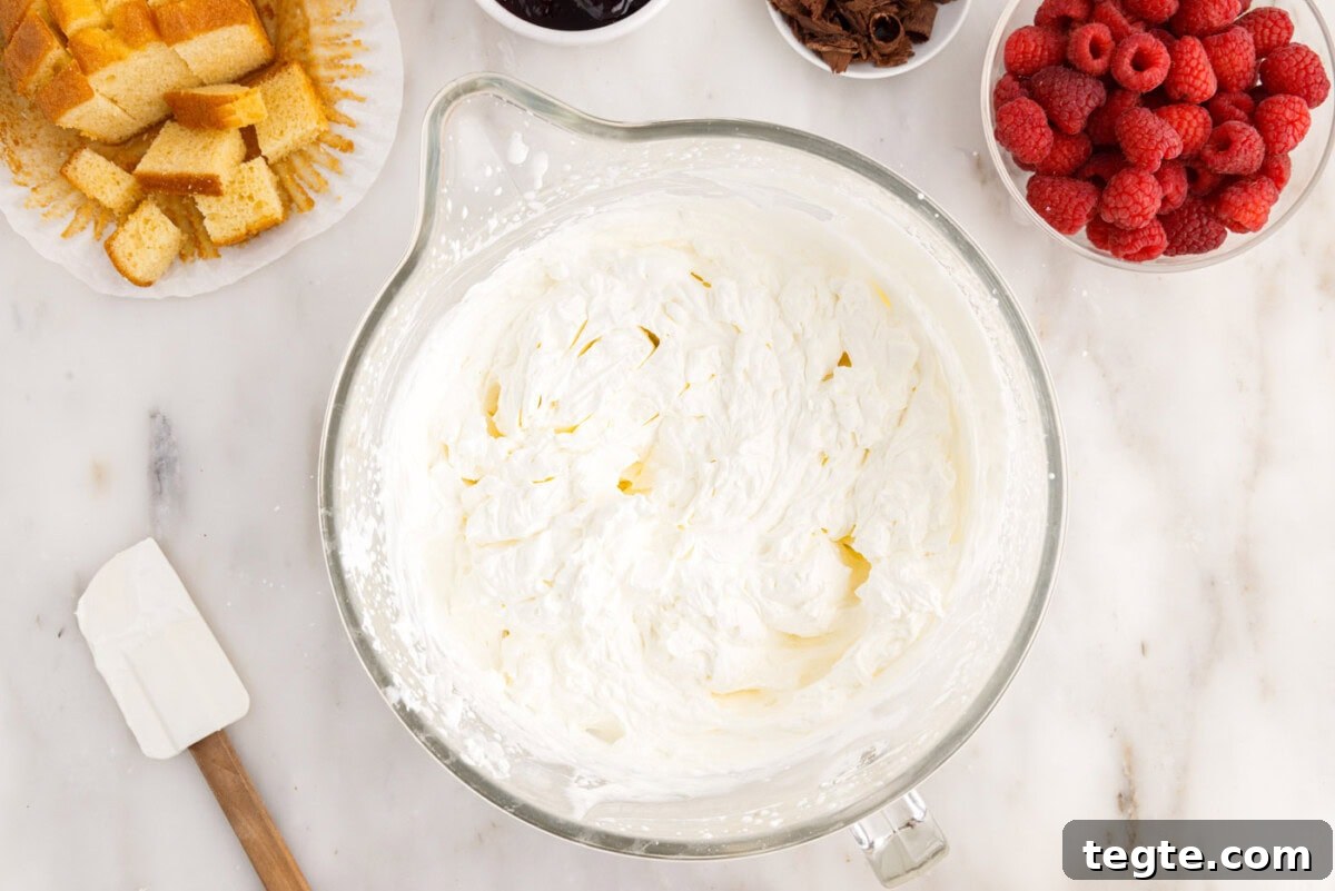 Decadent Raspberry Trifle Recipe with Fresh Cream and Cake 8 whipped cream in a bowl