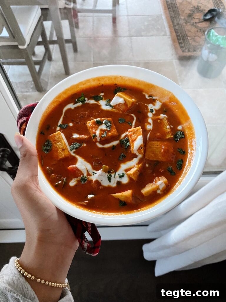 hand holding the paneer makhani