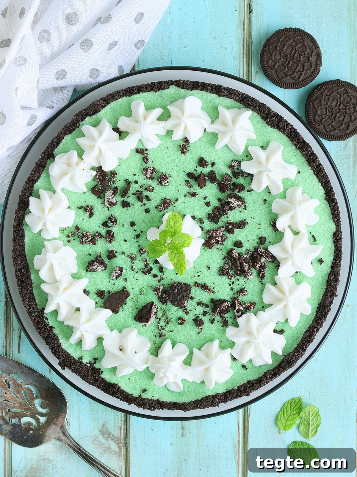 Classic Grasshopper Pie Recipe: Mint Chocolate Cream Pie 17 Grasshopper pie garnished with piped whipped cream, crushed cookies, and a mint sprig.