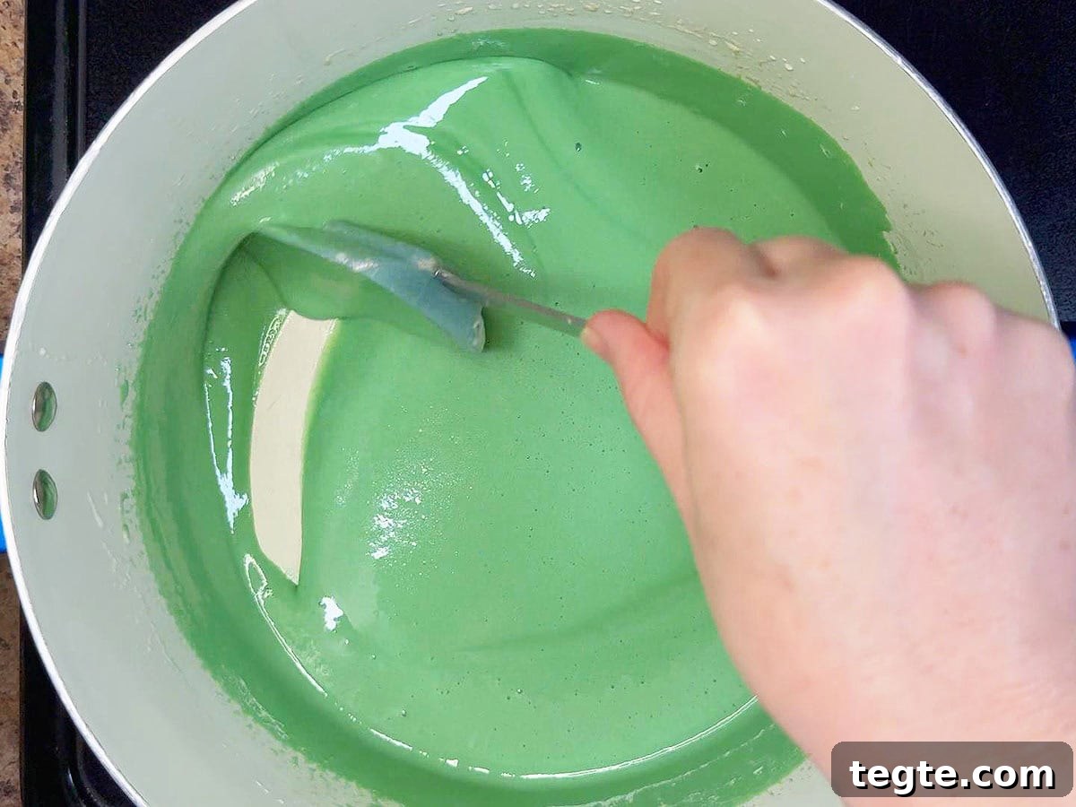 Classic Grasshopper Pie Recipe: Mint Chocolate Cream Pie 8 Stirring the creme de menthe, creme de cacao, and green food coloring into the melted marshmallows.