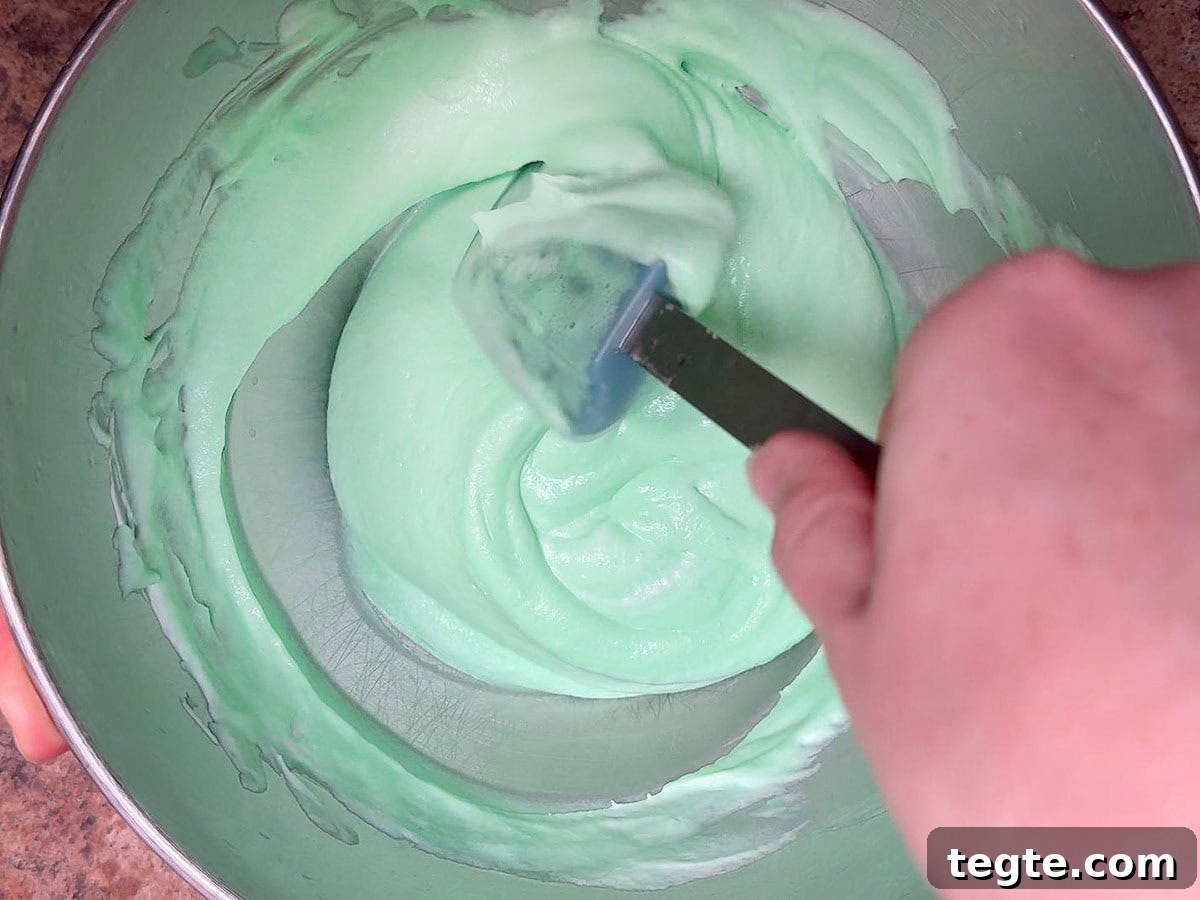 Classic Grasshopper Pie Recipe: Mint Chocolate Cream Pie 9 Folding the melted marshmallows into the whipped cream.