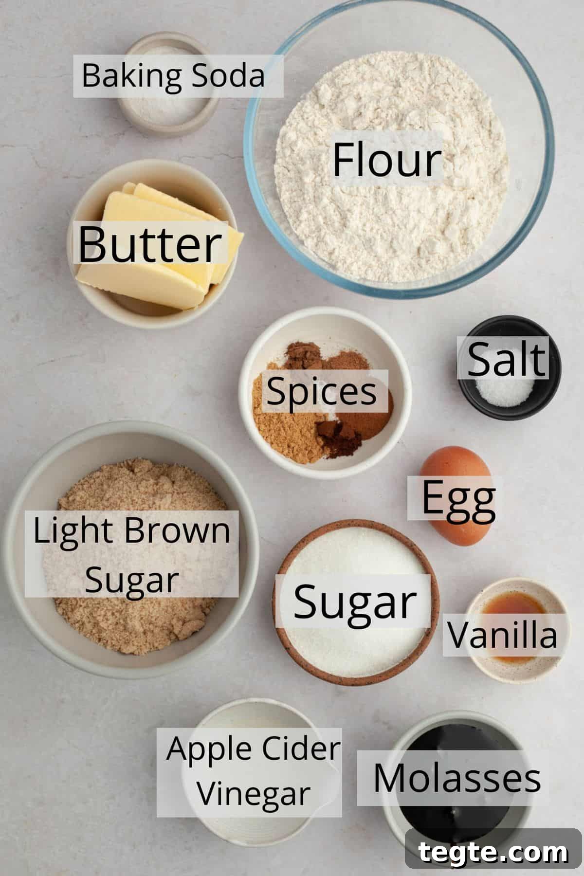All the ingredients needed to make molasses crinkle cookies weighed out into small bowls.
