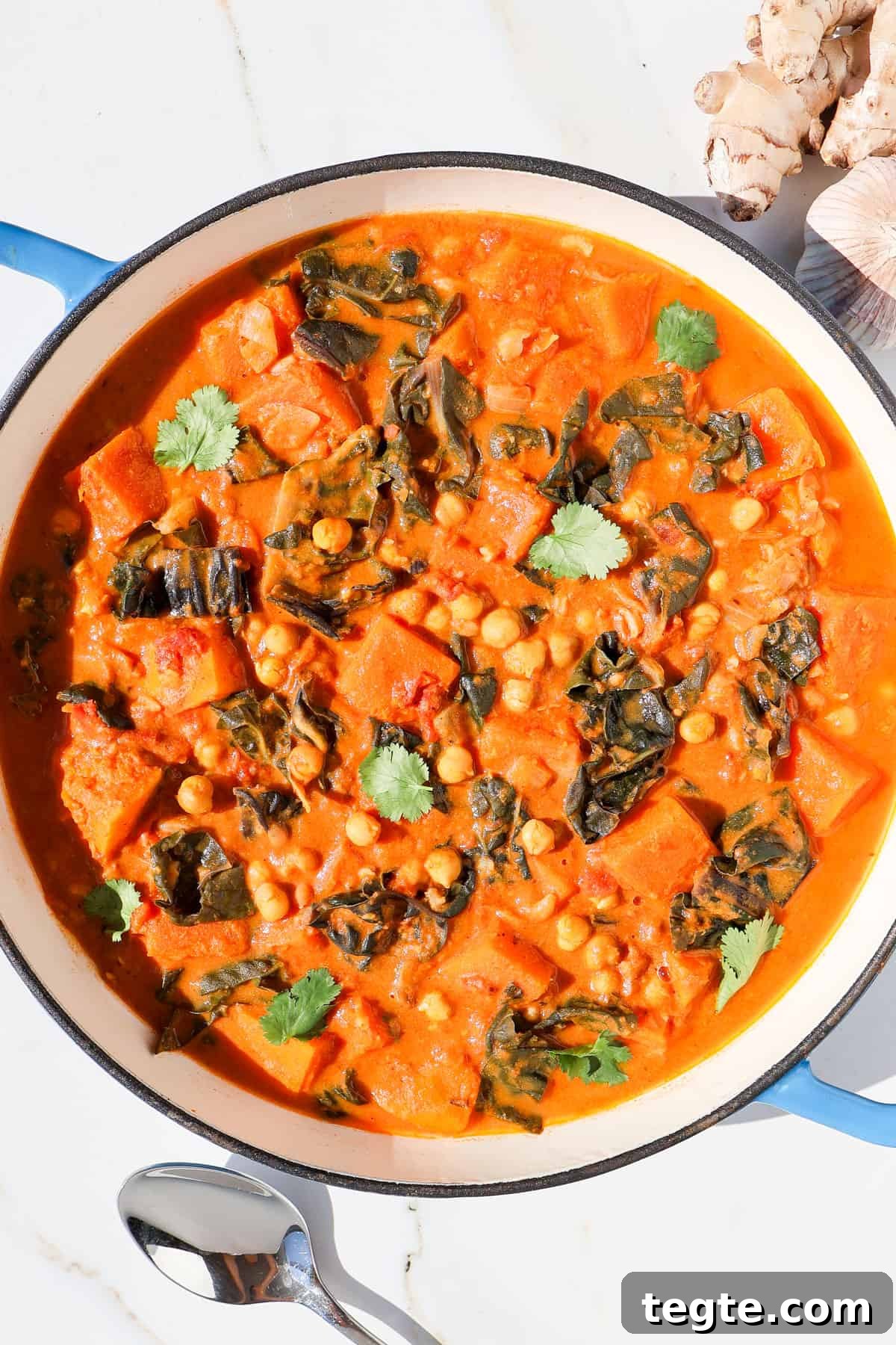 Butternut Squash and Chickpea Curry Recipe for Cozy Dinners 3 Butternut squash curry in a pot topped with coriander.