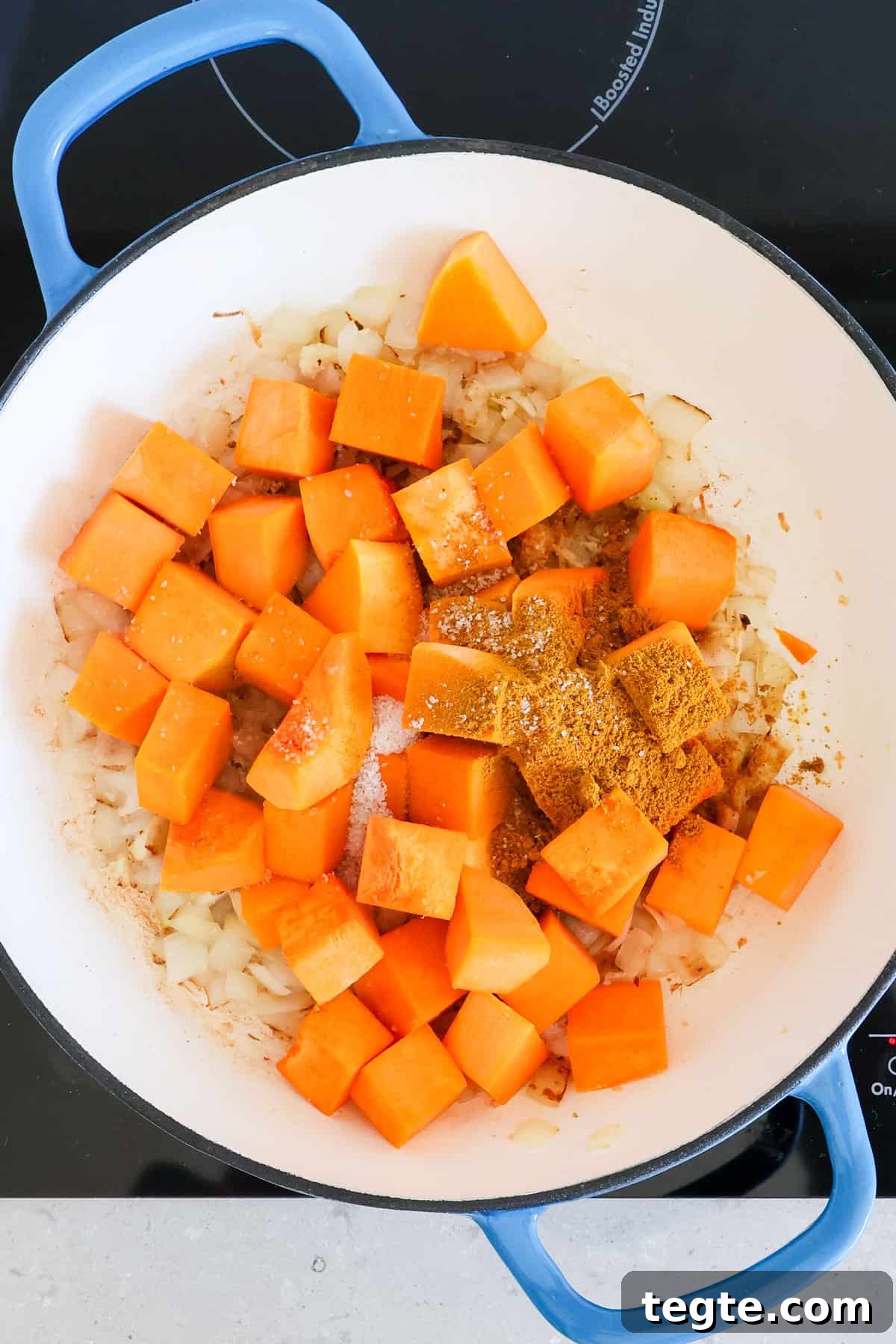 Butternut Squash and Chickpea Curry Recipe for Cozy Dinners 6 Butternut squash, curry powder and salt added to the pot.