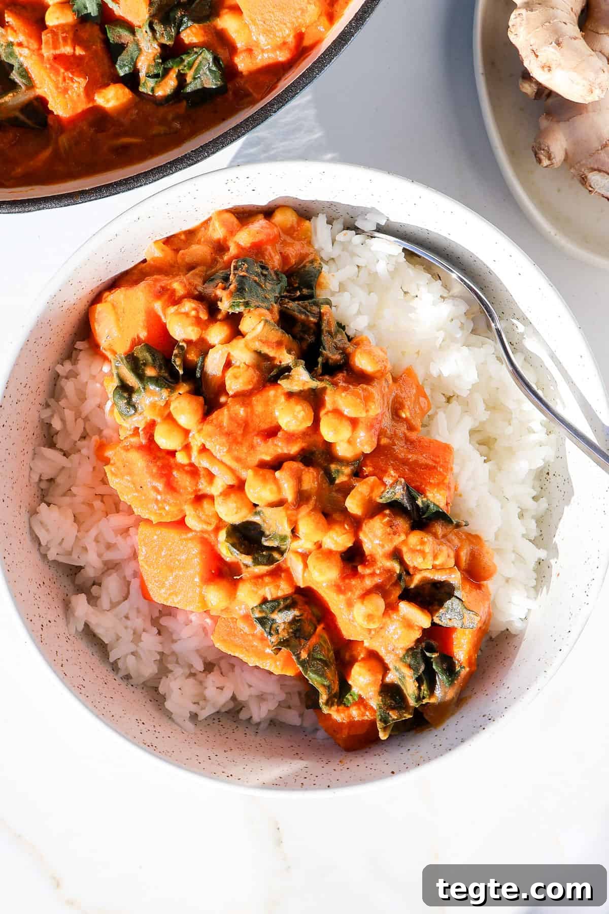 Butternut Squash and Chickpea Curry Recipe for Cozy Dinners 9 Butternut squash an chickpea curry served in a bowl with rice.