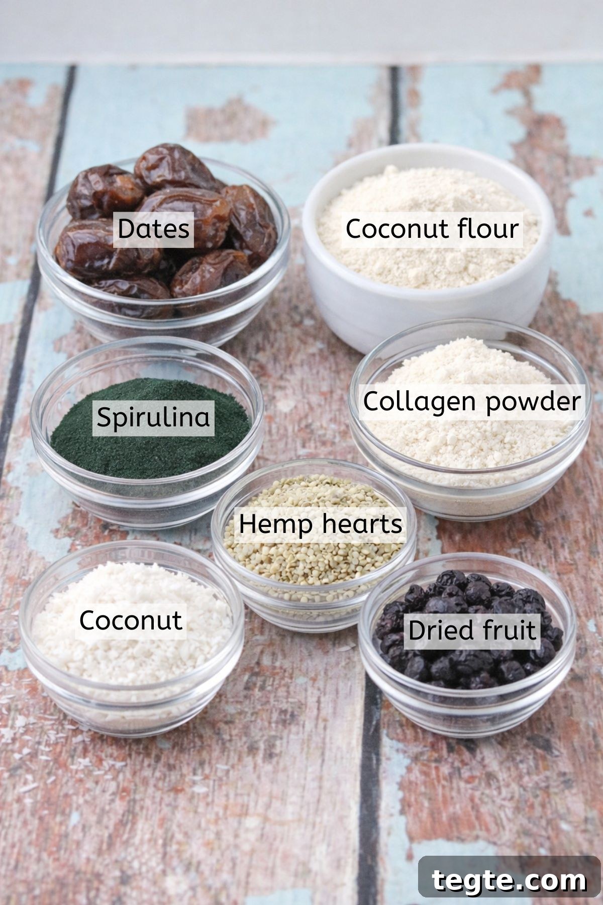 Energizing Spirulina Protein Balls (Gluten-Free) 3 Coconut, spirulina, dates, dried fruit and more in glass bowls with text labels over top.