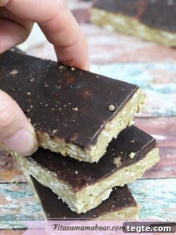 Three homemade protein bars with chocolate on top.