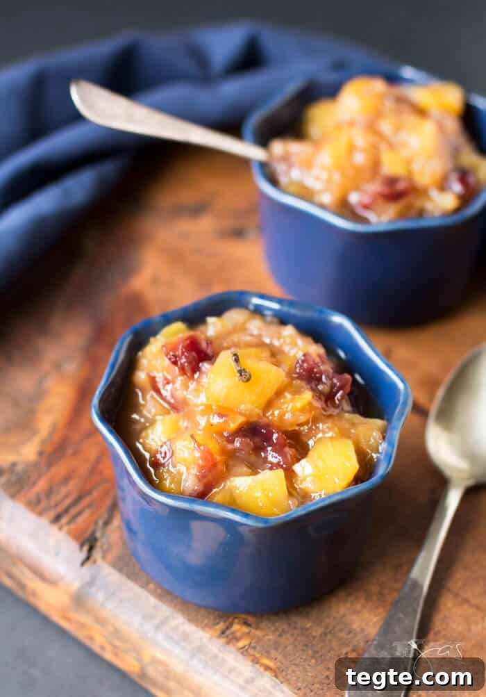 Two blue ramekins with mango chutney and spoons