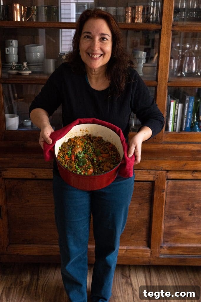 Authentic Puerto Rican Arroz con Pollo Recipe: Traditional Flavor Guide 13 My mom holding a pot of arroz con pollo.