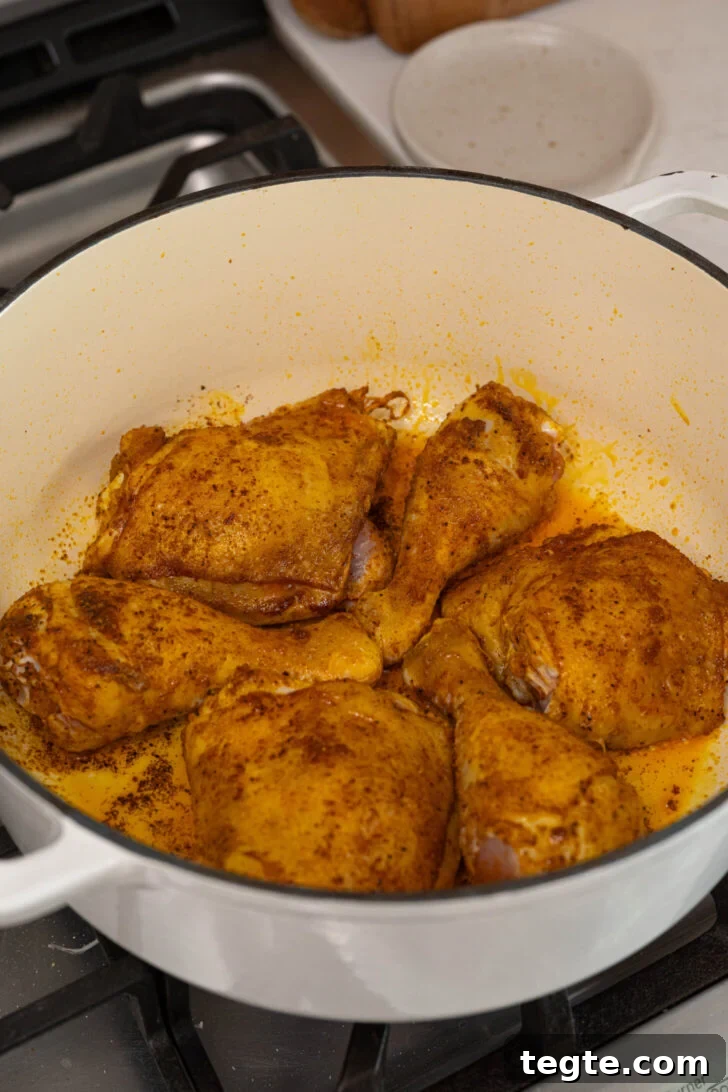 Authentic Puerto Rican Arroz con Pollo Recipe: Traditional Flavor Guide 6 Seasoned chicken searing in a pot.