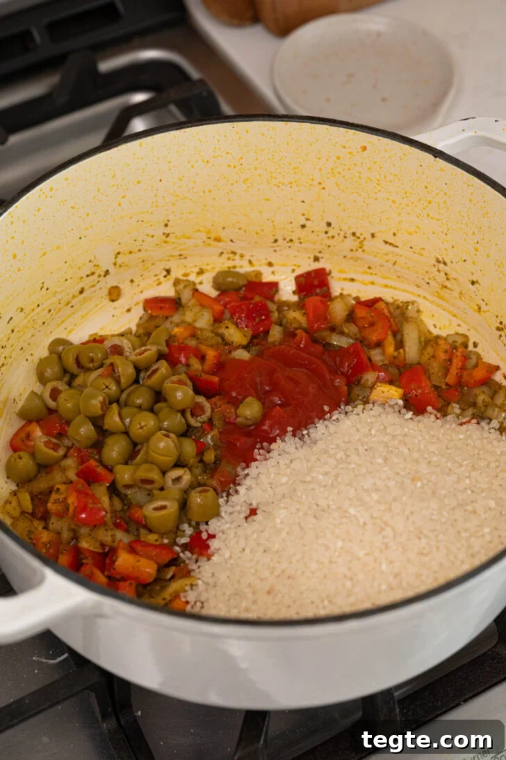 Authentic Puerto Rican Arroz con Pollo Recipe: Traditional Flavor Guide 8 A pot with rice, olives, and more.