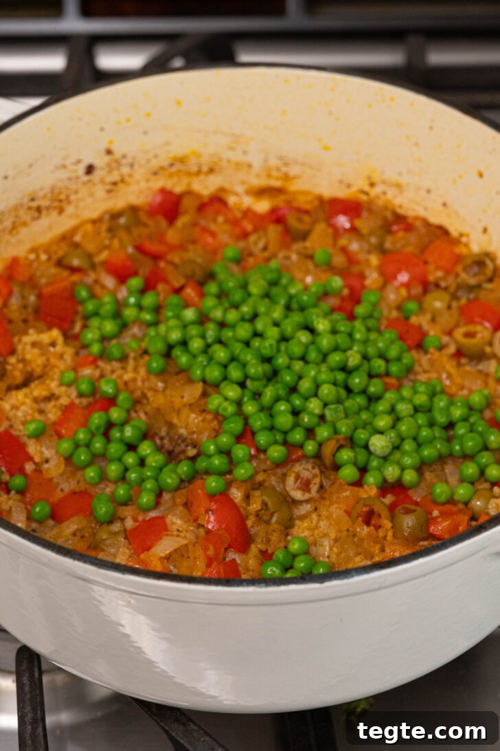 Authentic Puerto Rican Arroz con Pollo Recipe: Traditional Flavor Guide 10 Peas on top of a pot of arroz con pollo.