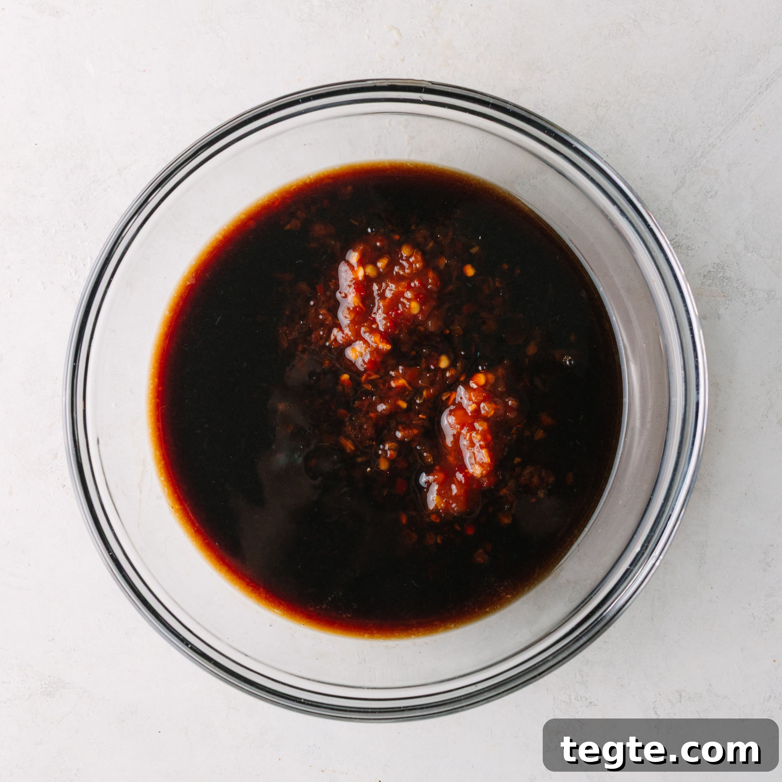 Asian Chili Garlic Chicken Wings Recipe 8 Asian wing sauce with chili garlic sauce being added.