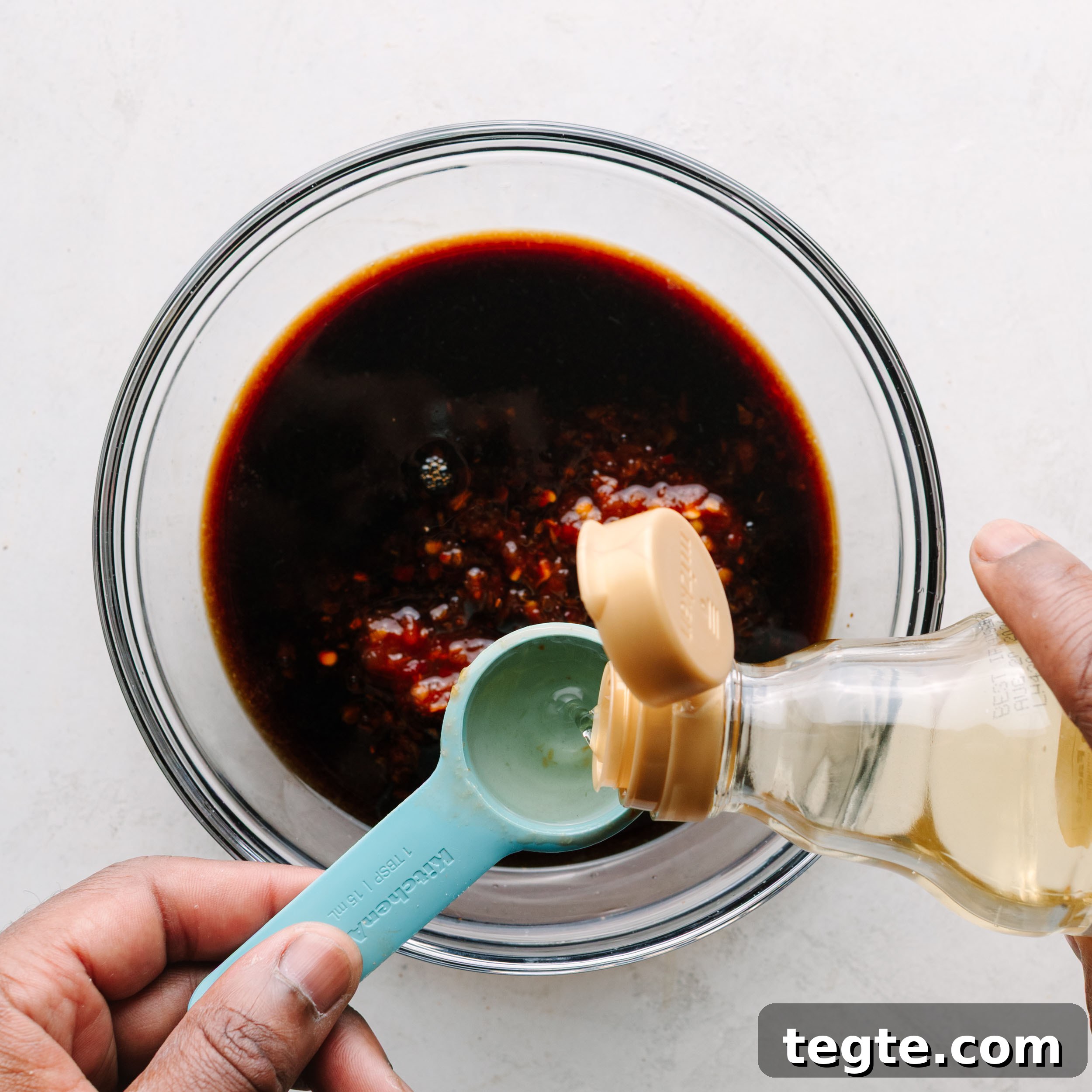 Asian Chili Garlic Chicken Wings Recipe 9 Asian wing sauce with rice wine vinegar being added.
