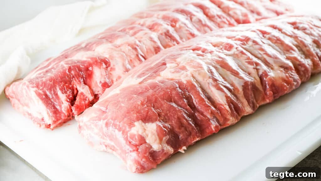 Two racks of baby rack ribs on cutting board