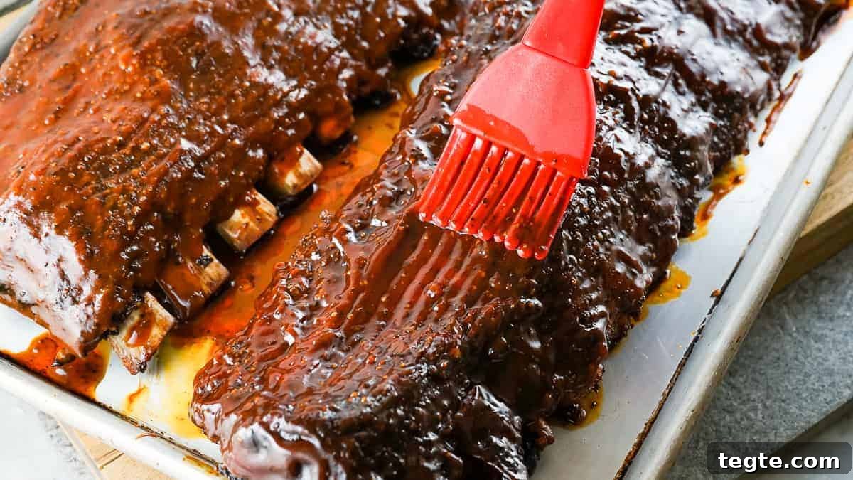 Basting brush applying bbq sauce to ribs